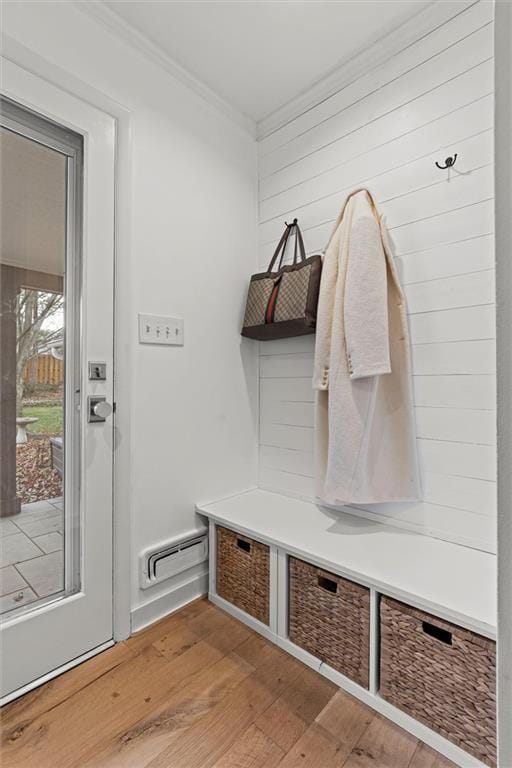 mudroom with hardwood / wood-style flooring, ornamental molding, and a baseboard heating unit