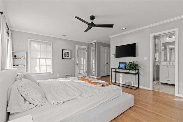 bedroom with crown molding, ceiling fan, ensuite bathroom, and light hardwood / wood-style flooring