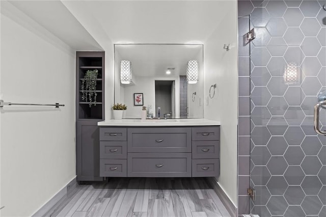 bathroom featuring vanity, hardwood / wood-style flooring, and walk in shower