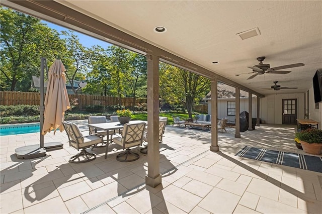 view of patio featuring ceiling fan and a fenced in pool