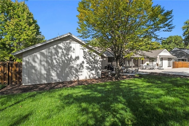 view of side of property with a patio and a yard