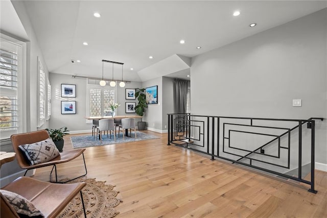 living area featuring lofted ceiling and light wood-type flooring