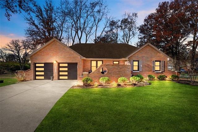 view of front of house with a yard and a garage