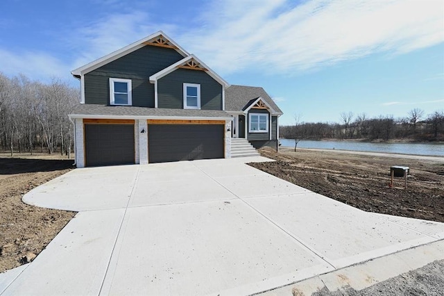 view of front facade featuring a garage and a water view