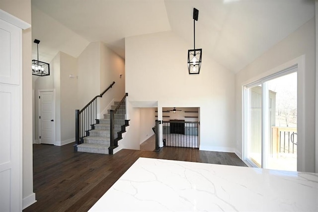 foyer with ceiling fan, dark hardwood / wood-style flooring, and high vaulted ceiling