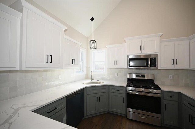 kitchen with decorative backsplash, stainless steel appliances, gray cabinets, and sink