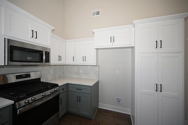 kitchen featuring gray cabinets, white cabinets, and stainless steel appliances