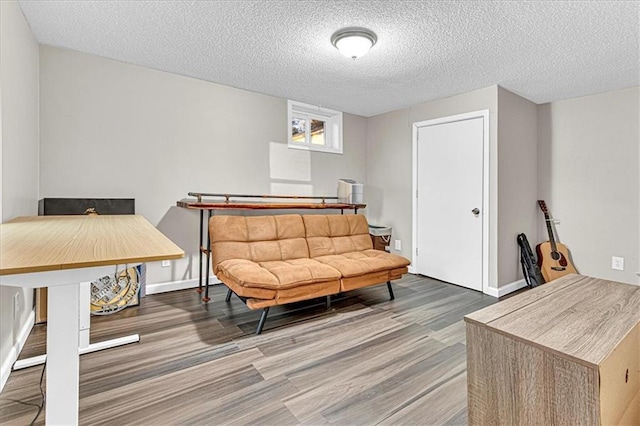 sitting room with hardwood / wood-style floors and a textured ceiling