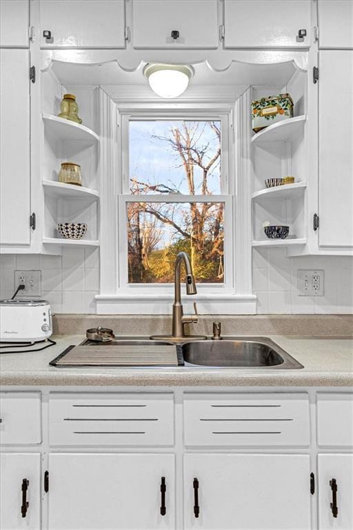 kitchen featuring decorative backsplash and white cabinetry