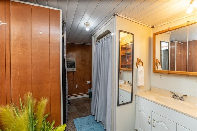 bathroom with vanity, wooden ceiling, wooden walls, and heating unit