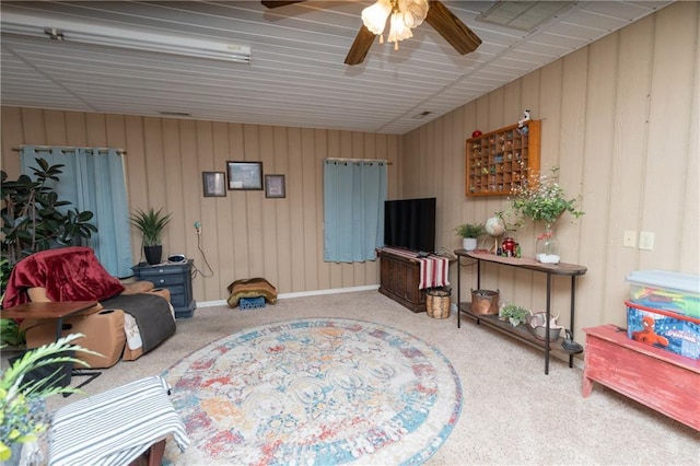 living room featuring carpet and ceiling fan