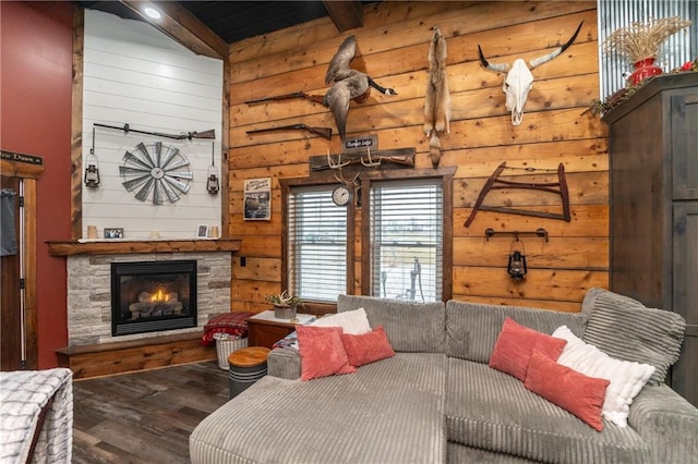 living room featuring a fireplace, hardwood / wood-style floors, and lofted ceiling with beams