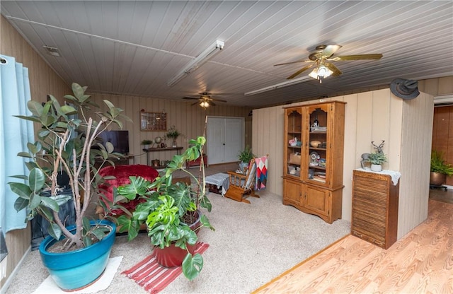 interior space with carpet flooring and ceiling fan