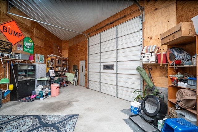 garage featuring wood walls