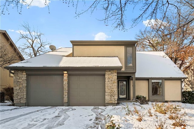 view of front of property featuring central air condition unit and a garage