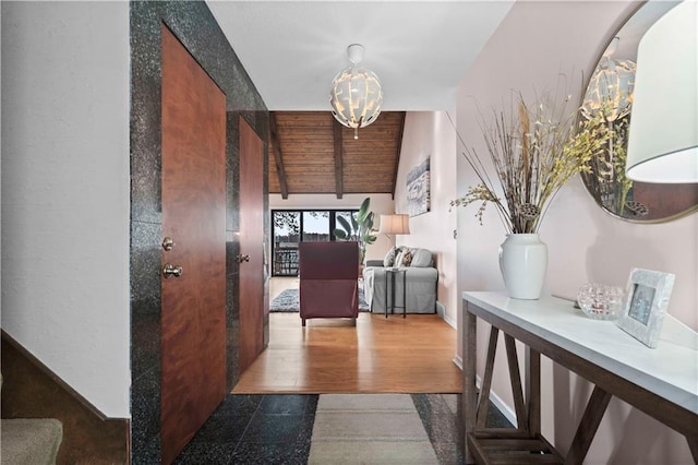 hallway featuring hardwood / wood-style flooring and lofted ceiling