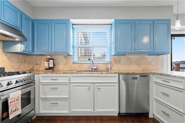 kitchen featuring sink, stainless steel appliances, tasteful backsplash, light stone counters, and dark hardwood / wood-style floors