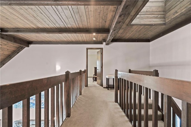 corridor featuring light carpet, wooden ceiling, and lofted ceiling with skylight