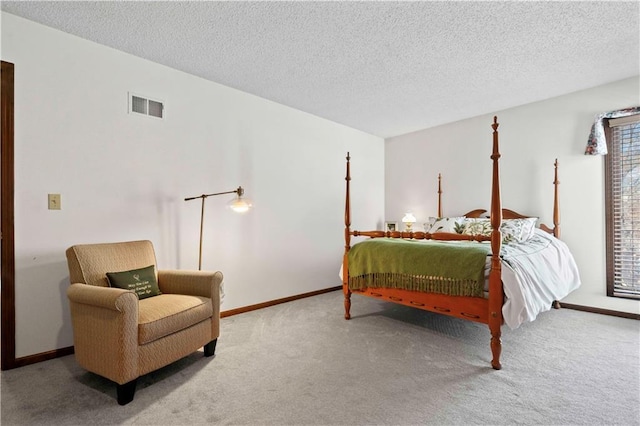 bedroom with carpet flooring and a textured ceiling