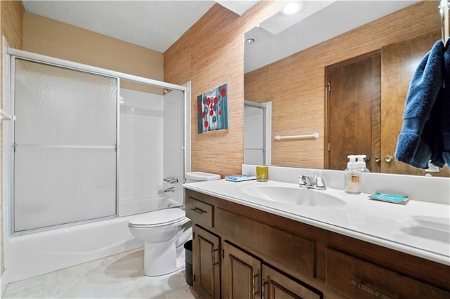 full bathroom featuring wood walls, vanity, toilet, and combined bath / shower with glass door