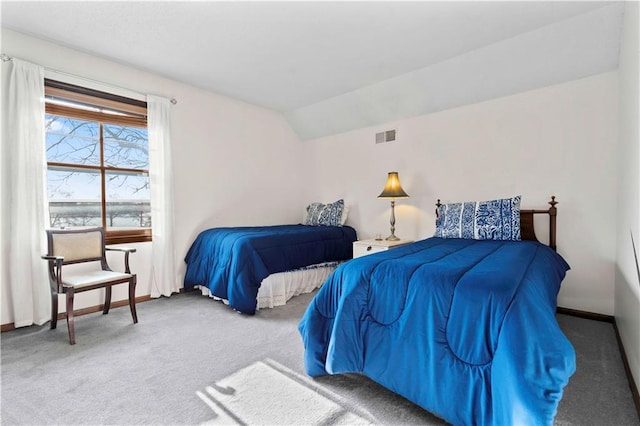 carpeted bedroom featuring lofted ceiling