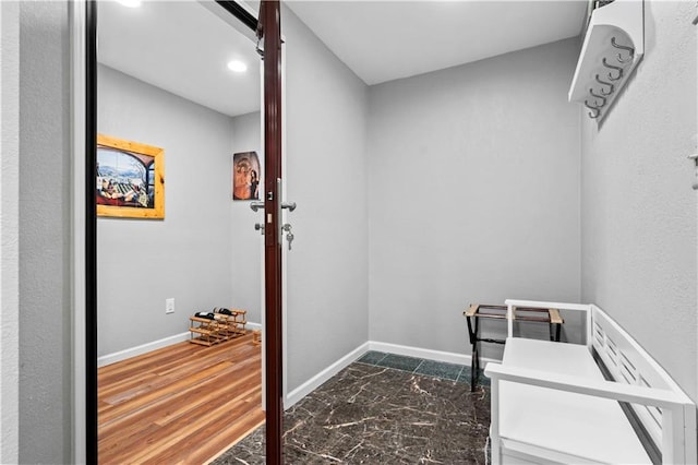 interior space with a barn door and dark hardwood / wood-style flooring