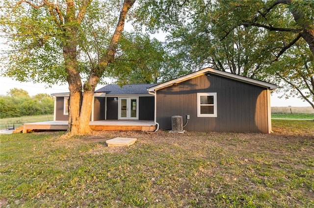 rear view of house featuring a yard, central AC, french doors, and a deck