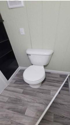 bathroom featuring hardwood / wood-style floors and toilet