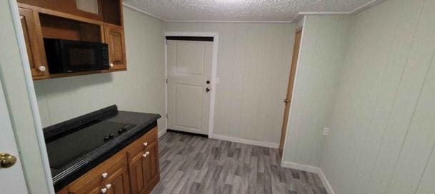 kitchen with a textured ceiling and light hardwood / wood-style flooring