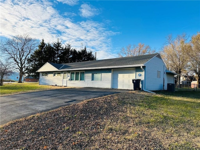 single story home with a garage and a front lawn