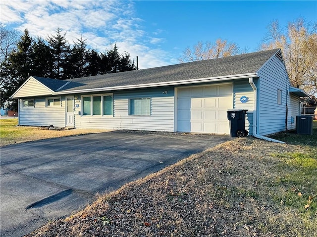 view of front of home with cooling unit and a garage