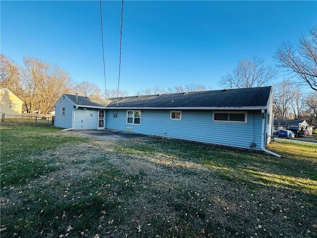 rear view of house with a yard and a patio area