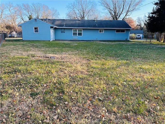 back of house featuring a yard