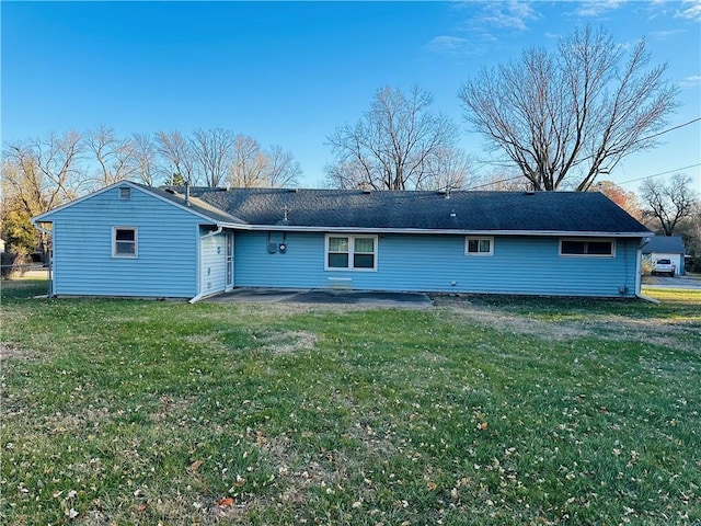 rear view of house featuring a patio area and a lawn