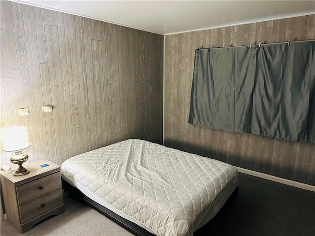 carpeted bedroom with wooden walls