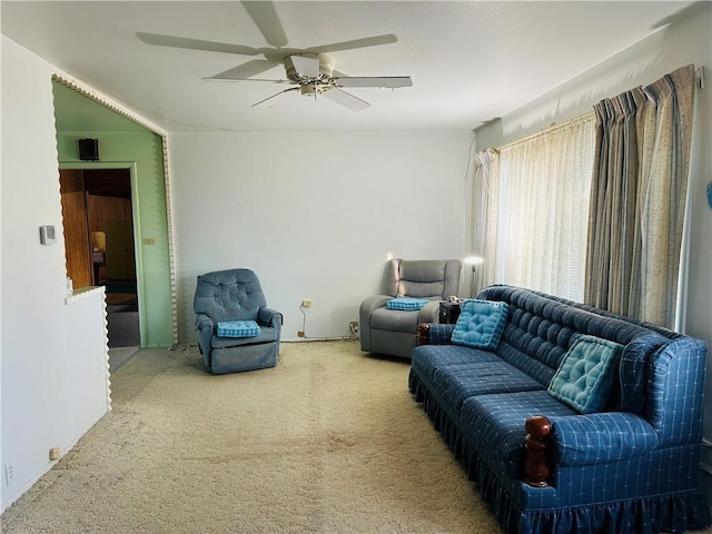 living room featuring carpet and ceiling fan