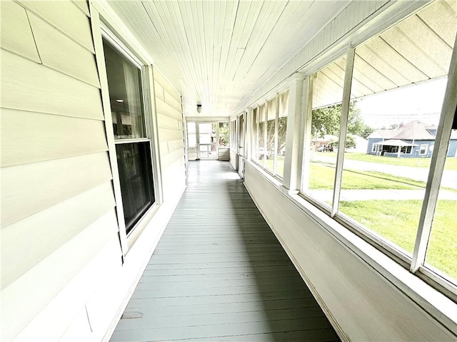 unfurnished sunroom with wood ceiling