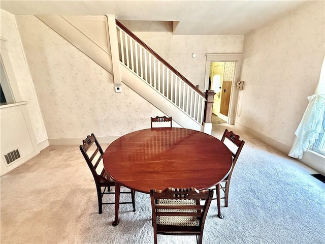 dining room featuring light colored carpet