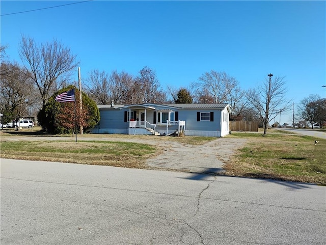 view of front of home with a porch and a front lawn