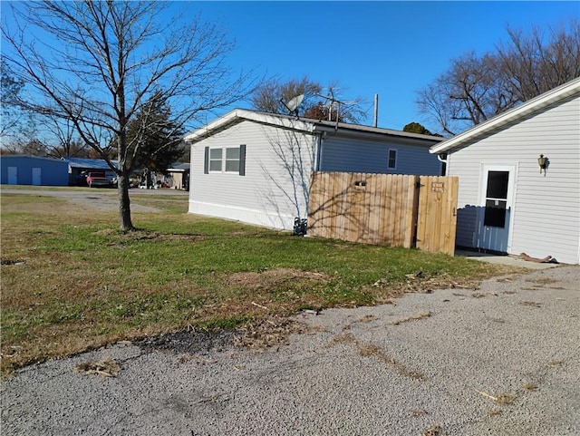 view of side of home featuring a lawn