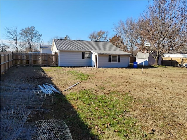 back of house with a lawn