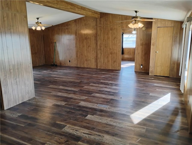 unfurnished room featuring vaulted ceiling with beams, wood walls, and dark wood-type flooring