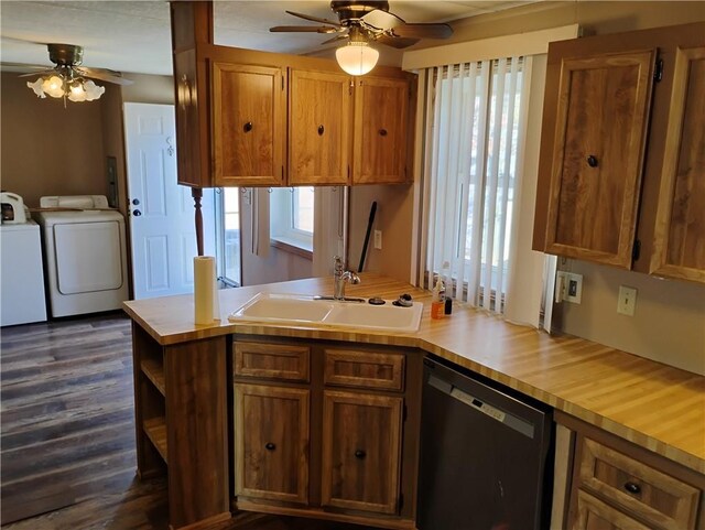 kitchen featuring dishwasher, sink, dark wood-type flooring, kitchen peninsula, and washer and clothes dryer