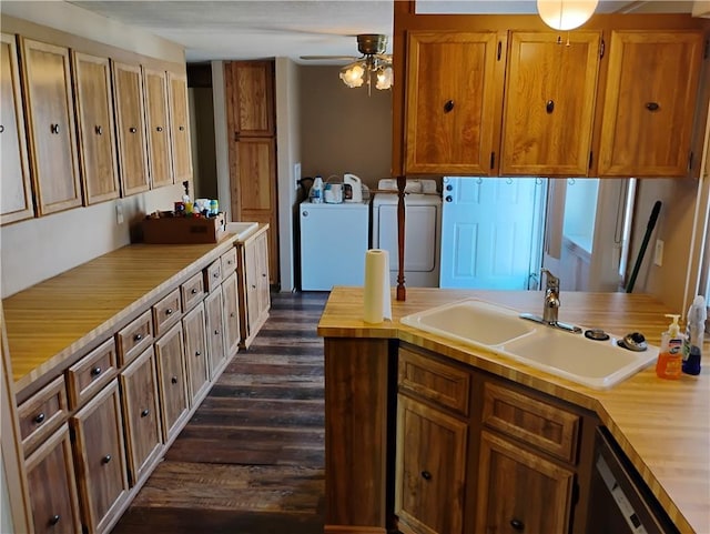 kitchen featuring dishwasher, sink, washer and dryer, ceiling fan, and dark hardwood / wood-style flooring