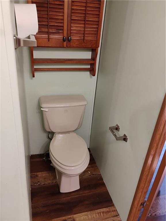 bathroom featuring hardwood / wood-style floors and toilet