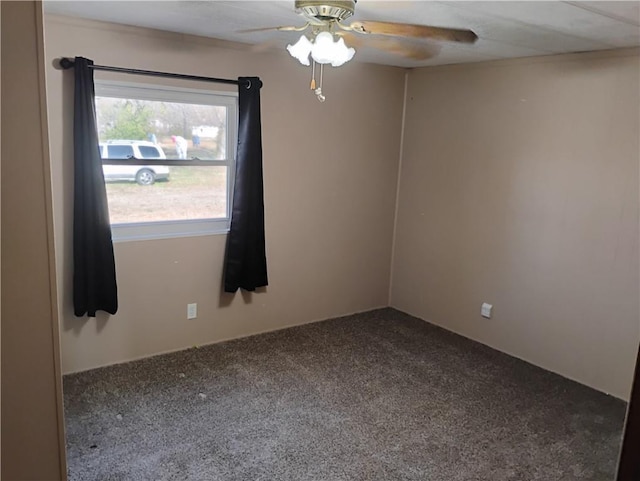 carpeted spare room featuring ceiling fan