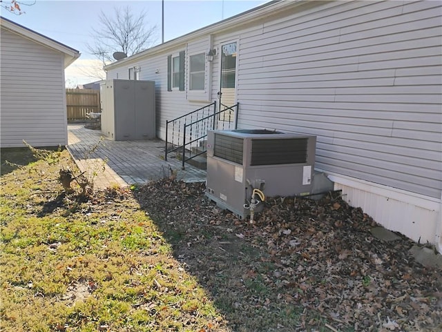 view of property exterior featuring central AC unit and a patio area