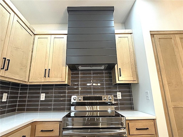 kitchen featuring ventilation hood, electric range, and tasteful backsplash