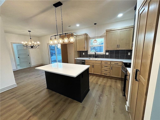 kitchen with pendant lighting, a center island, wood-type flooring, and sink