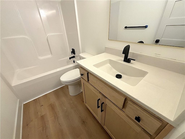 full bathroom with wood-type flooring, vanity, bathing tub / shower combination, and toilet